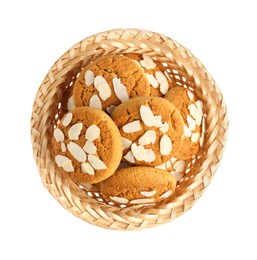 Photo of Tasty cookies with almond flakes in wicker basket isolated on white, top view