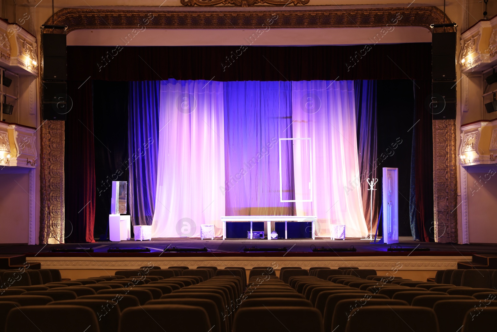 Photo of Theatre interior with stage and rows of comfortable seats