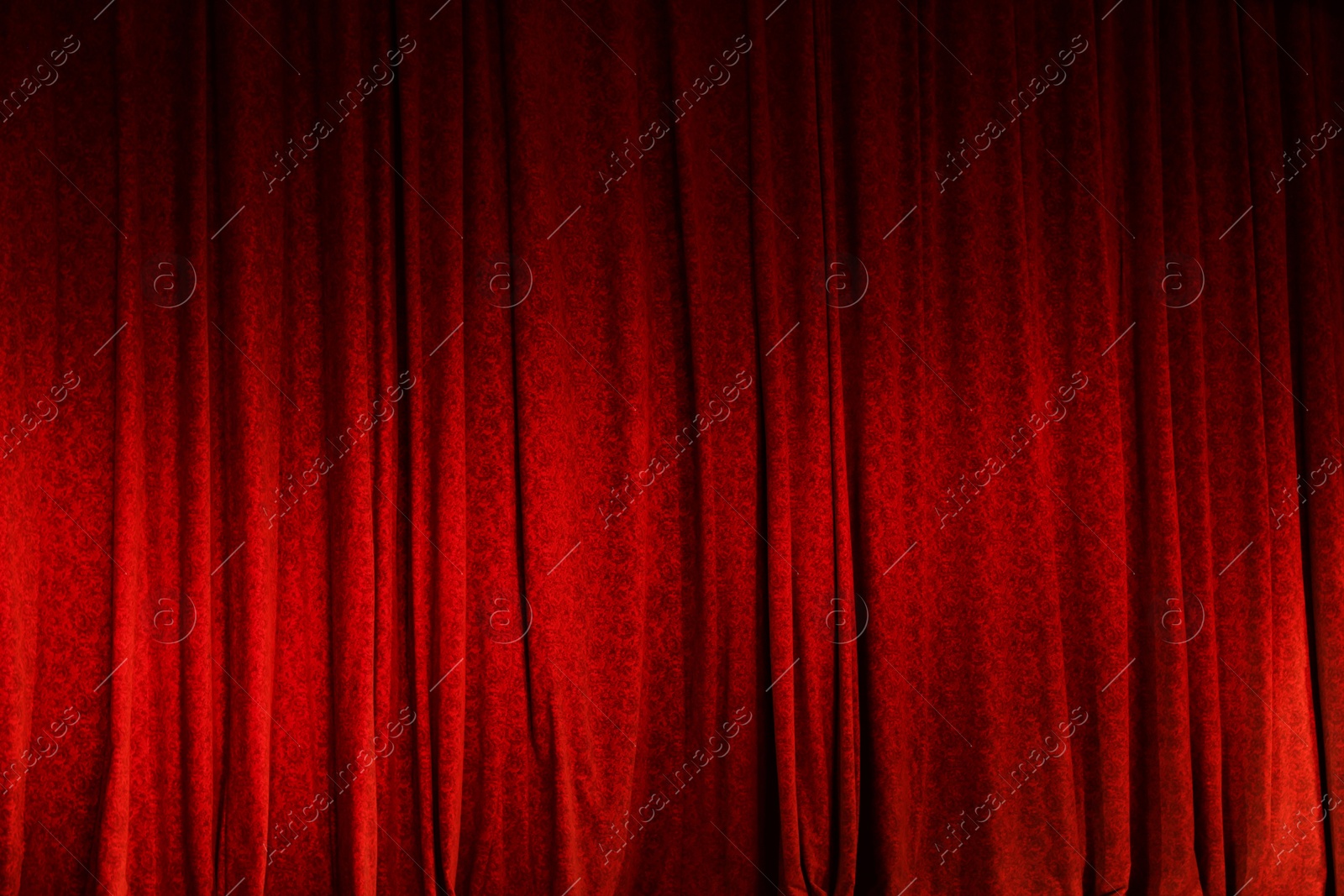 Photo of Elegant red curtains in theatre as background, closeup