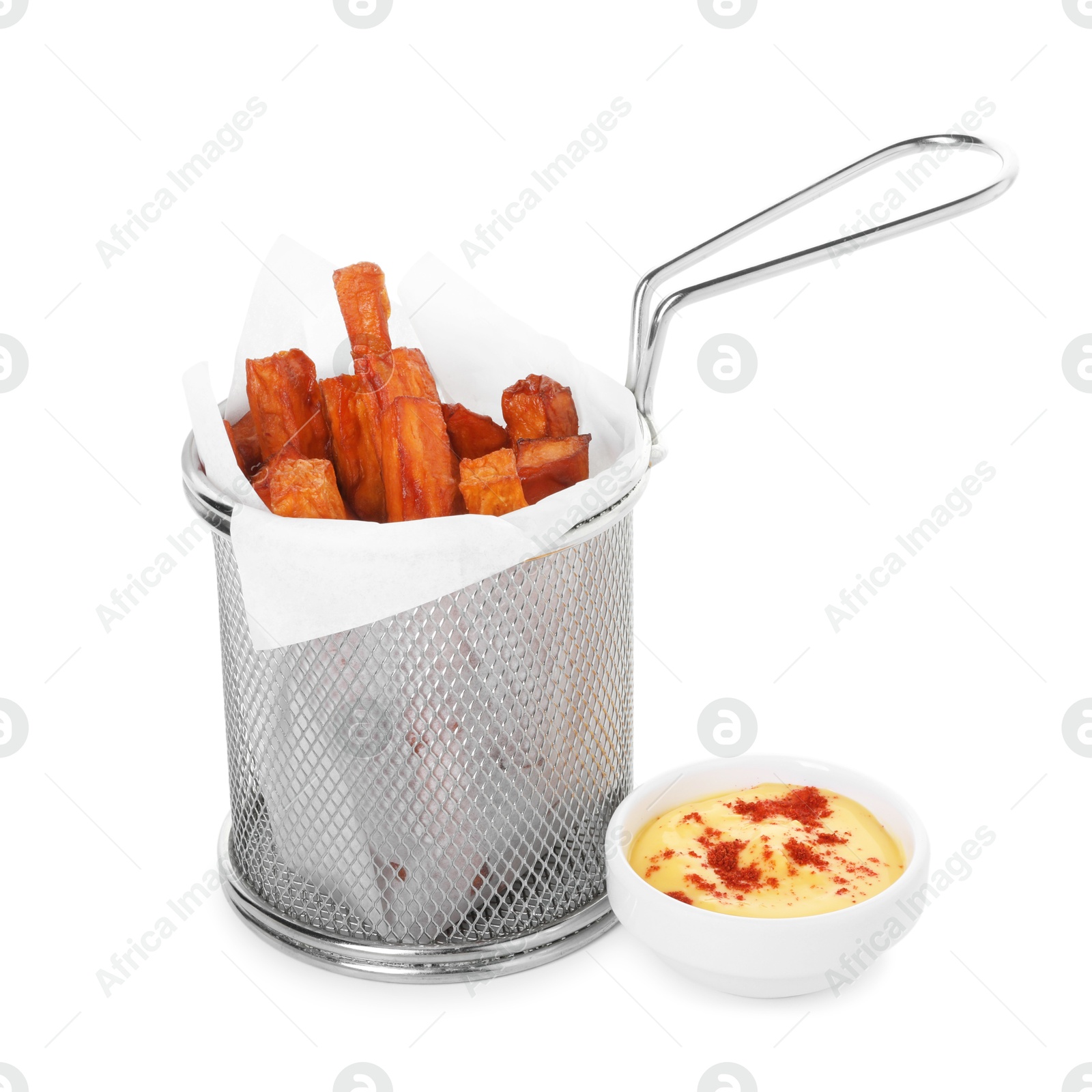 Photo of Sweet potato fries in metal basket and sauce isolated on white