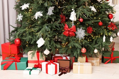 Many gifts under Christmas tree at home