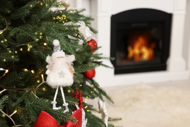 Christmas tree decorated with beautiful ornaments and lights indoors, closeup