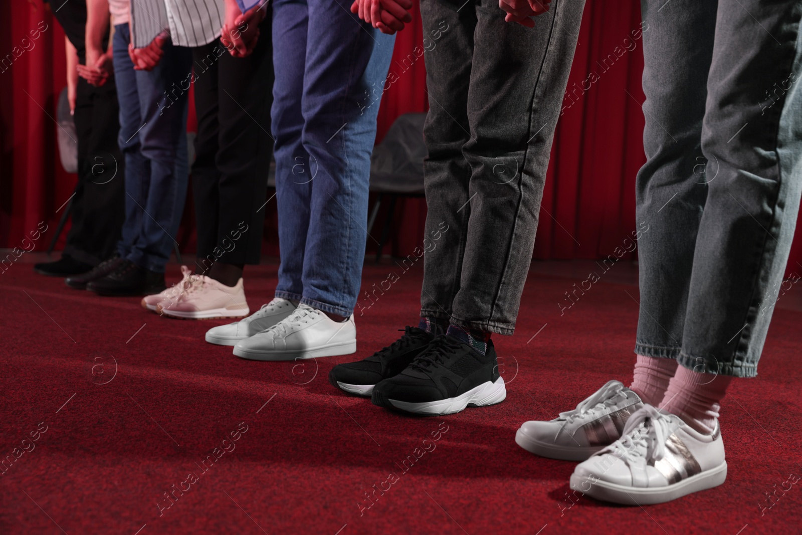 Photo of Professional actors bowing on stage in theatre, closeup