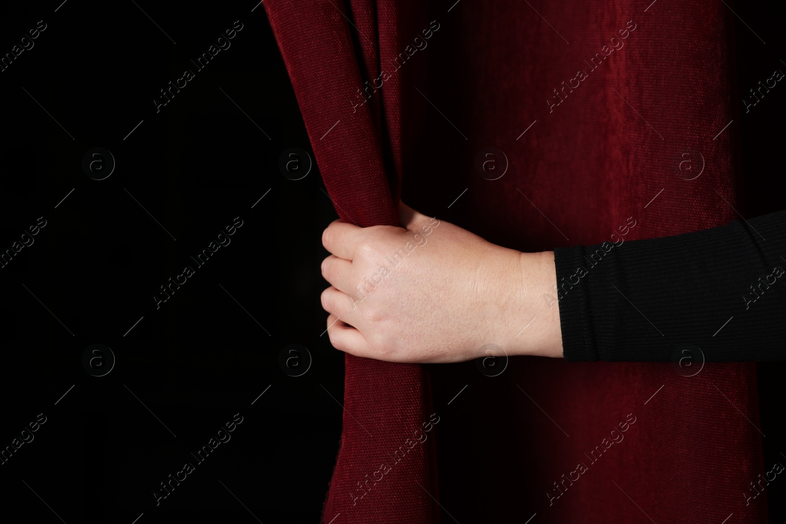 Photo of Woman opening red front curtains in theatre, closeup. Space for text