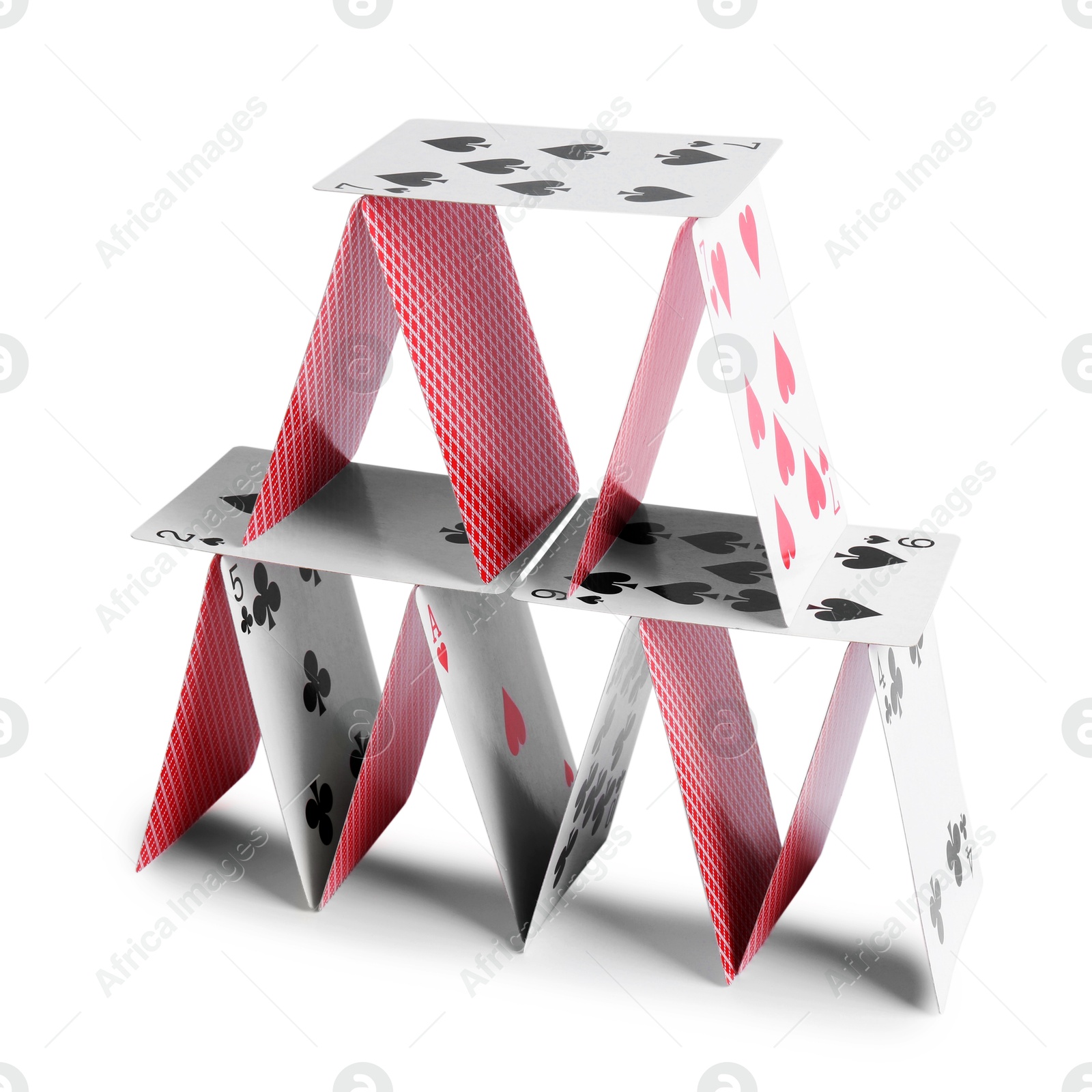 Photo of House of playing cards isolated on white