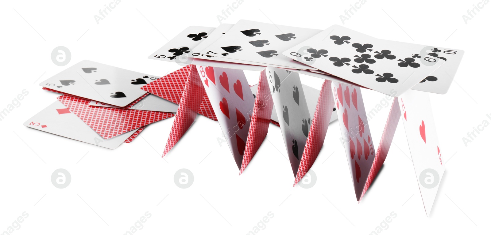 Photo of Collapsed house of playing cards isolated on white