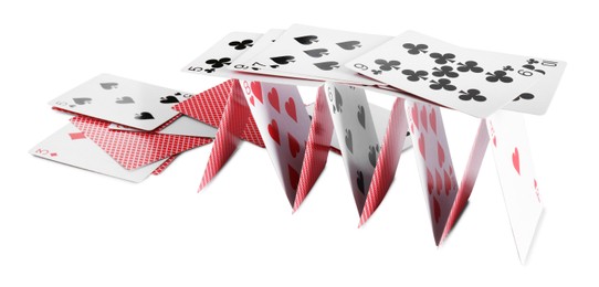 Photo of Collapsed house of playing cards isolated on white