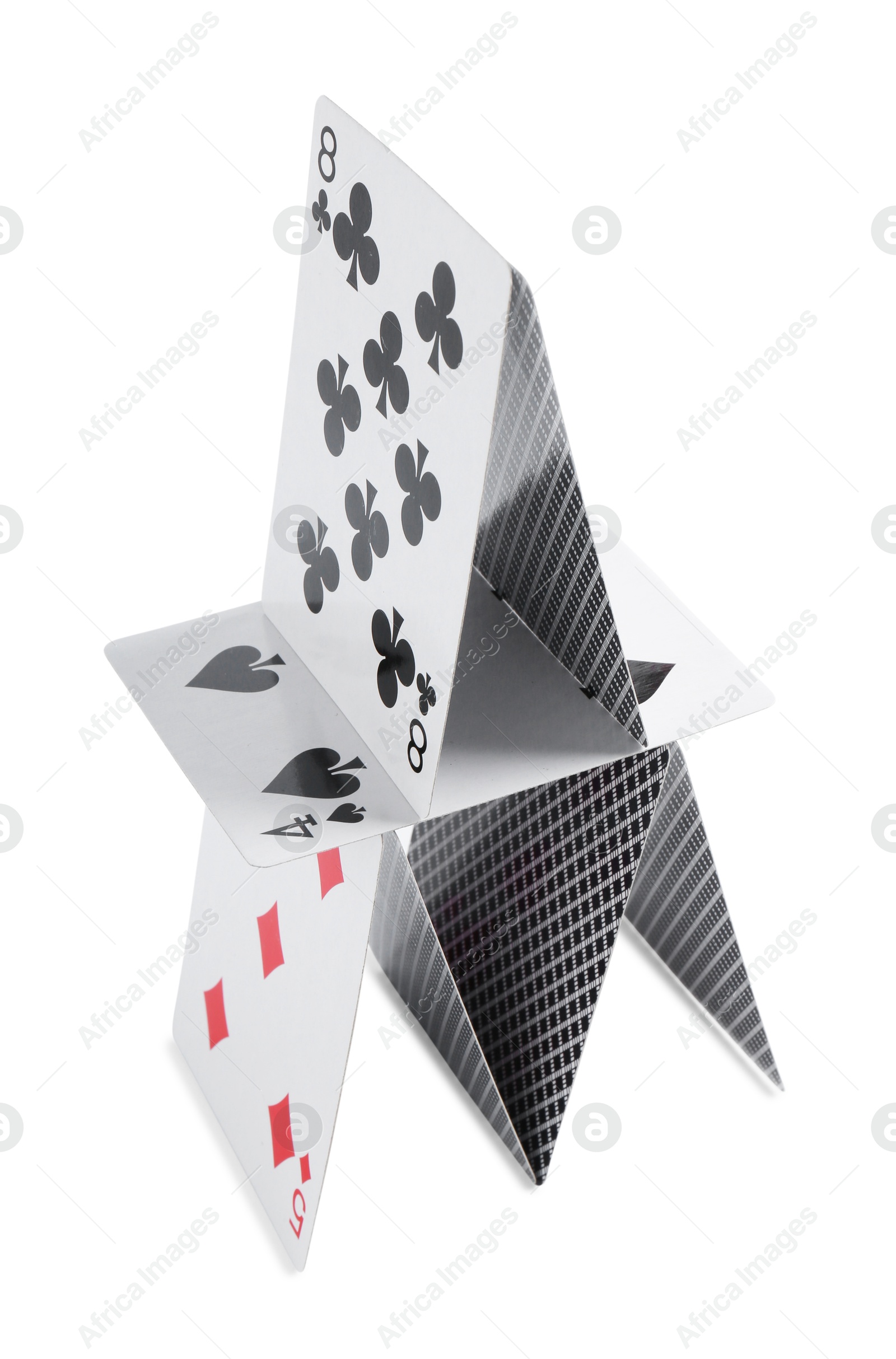 Photo of House of playing cards isolated on white