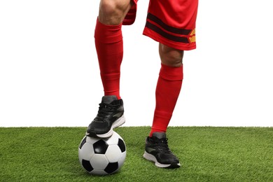 Photo of Football player with soccer ball on artificial grass against white background, closeup