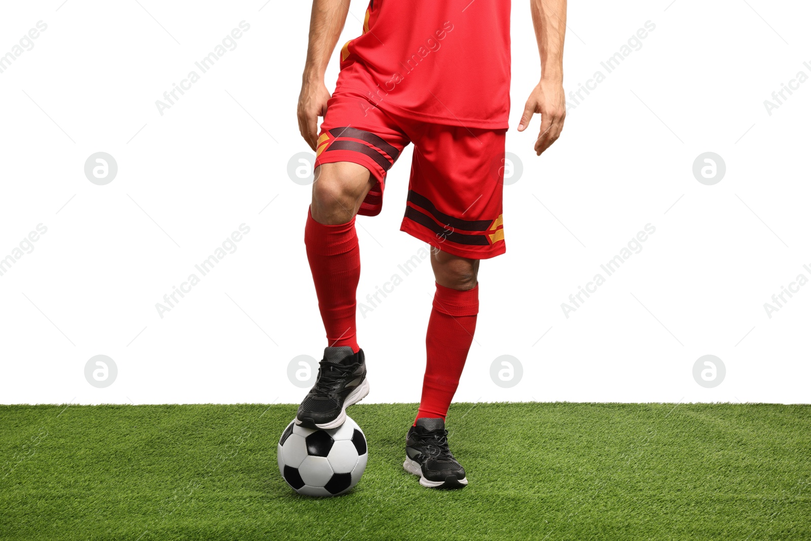 Photo of Football player with soccer ball on artificial grass against white background, closeup