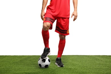 Photo of Football player with soccer ball on artificial grass against white background, closeup