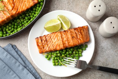 Photo of Delicious grilled salmon fillet served on grey textured table, flat lay