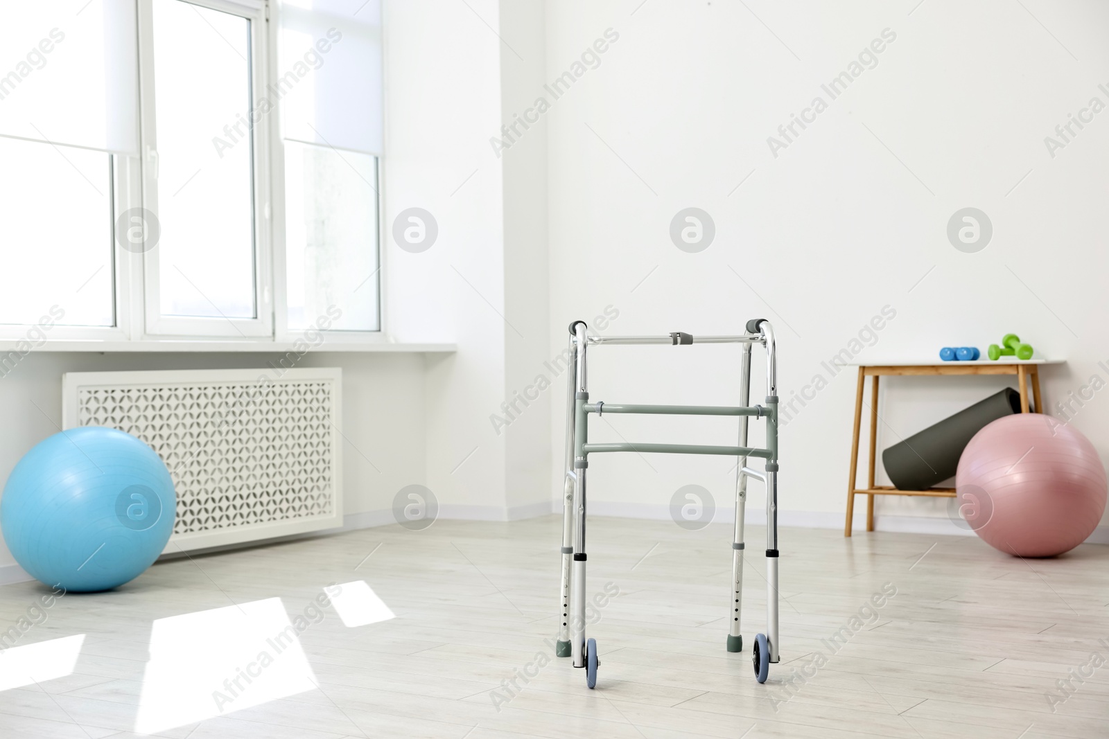 Photo of Metal walking frame in room. Medical equipment