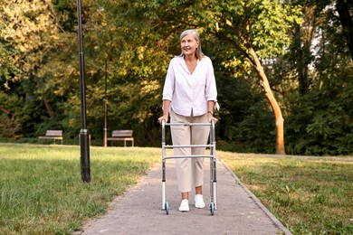 Photo of Senior woman with walking frame in park