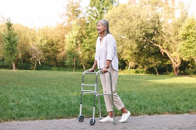 Photo of Senior woman with walking frame in park