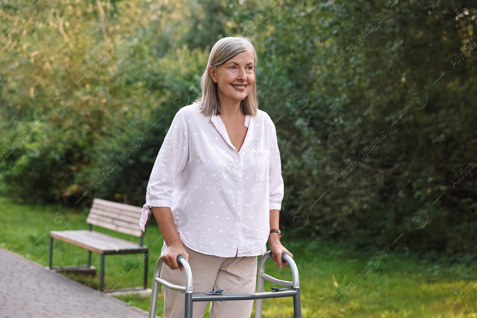 Photo of Senior woman with walking frame in park