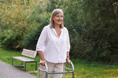 Photo of Senior woman with walking frame in park