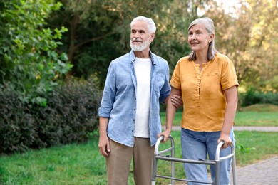 Senior couple with walking frame in park