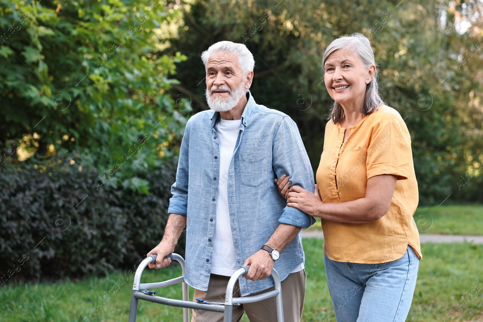 Photo of Senior couple with walking frame in park