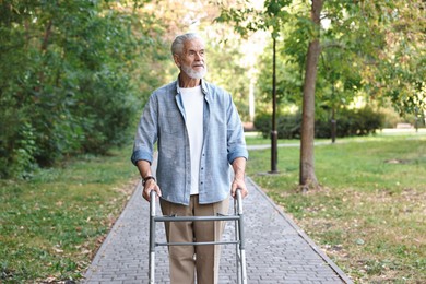 Photo of Senior man with walking frame in park