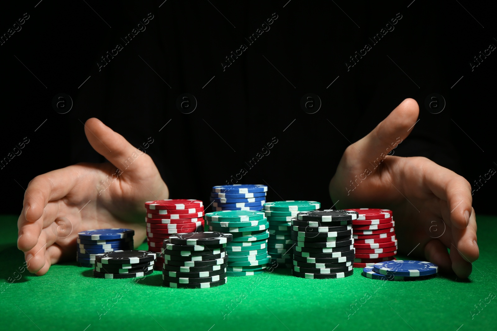 Photo of Woman with poker chips at green table, closeup