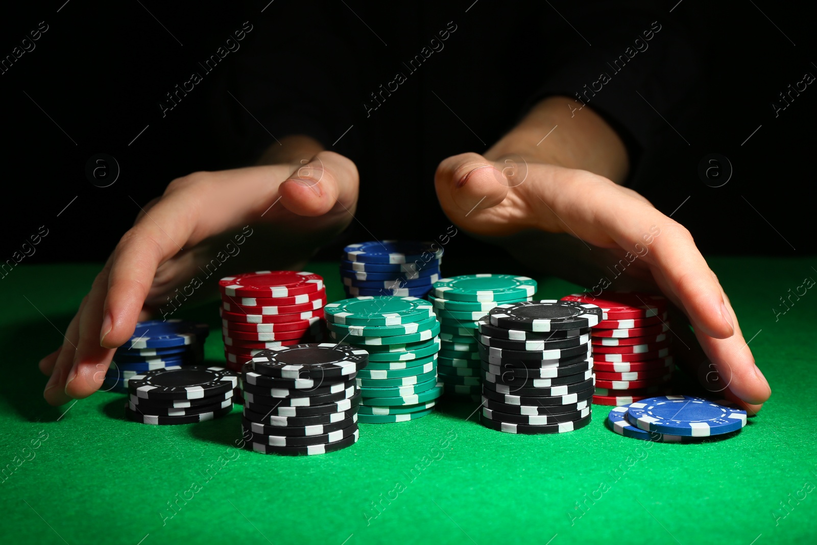 Photo of Woman with poker chips at green table, closeup