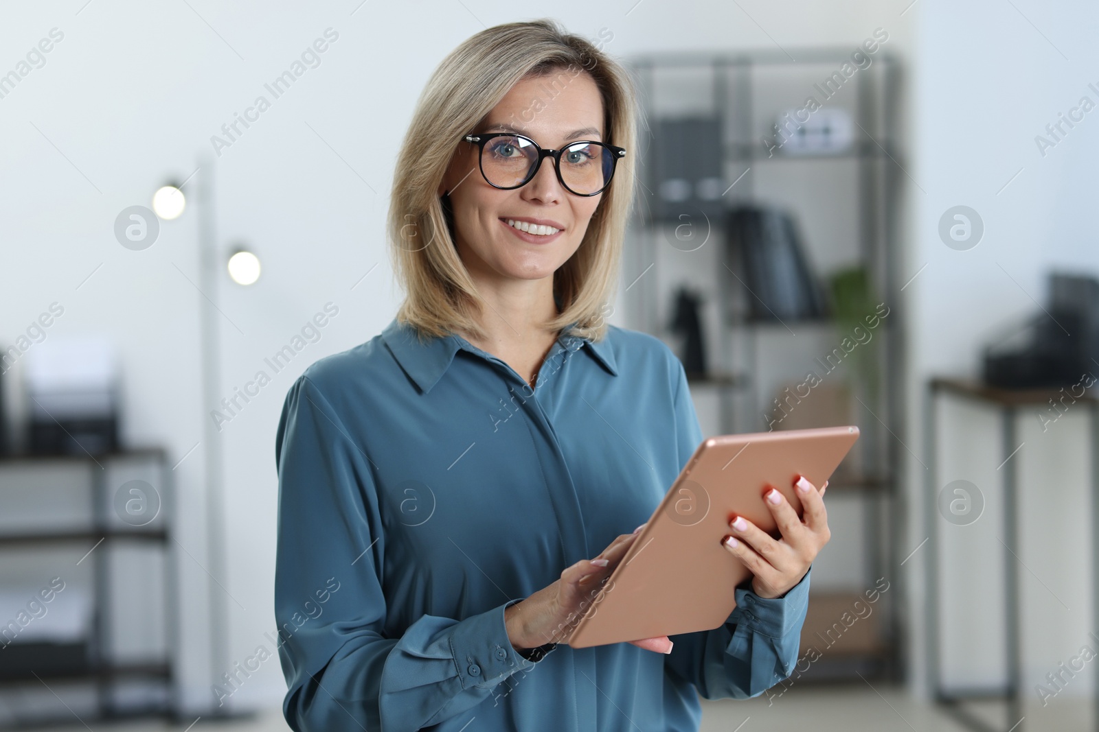 Photo of Portrait of businesswoman using tablet in office