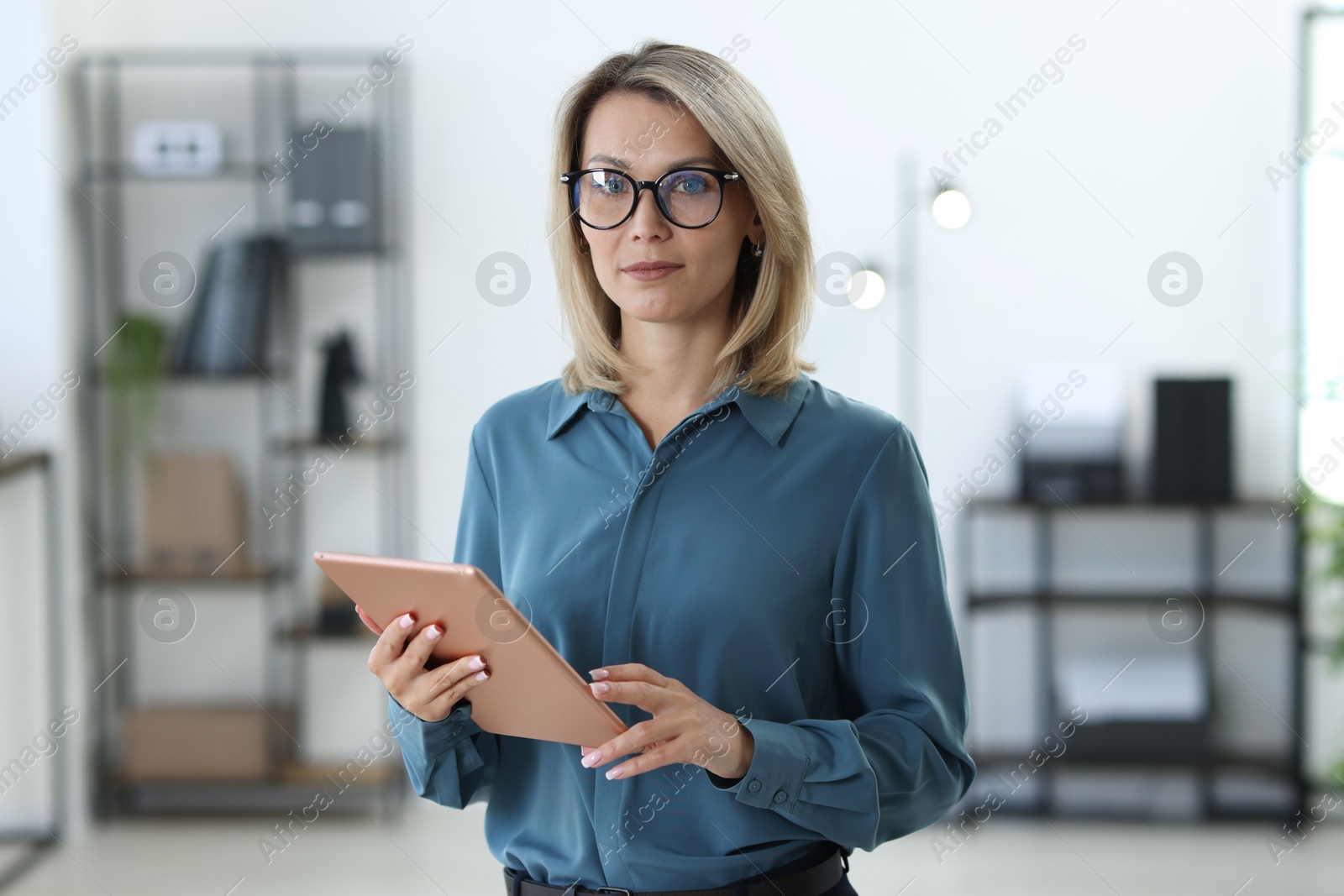 Photo of Portrait of businesswoman using tablet in office