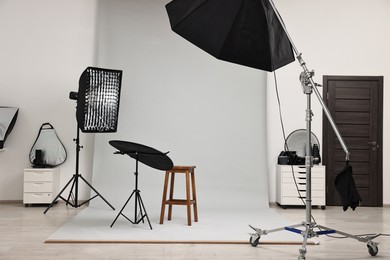 Photo of Professional lighting equipment setup in modern photo studio