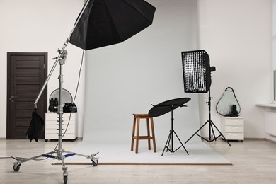 Photo of Professional lighting equipment setup in modern photo studio