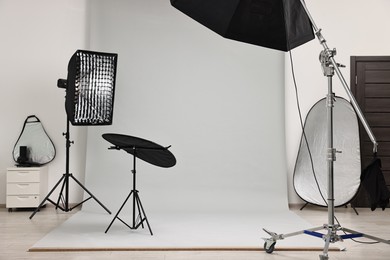 Photo of Professional lighting equipment setup in modern photo studio