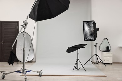 Photo of Professional lighting equipment setup in modern photo studio