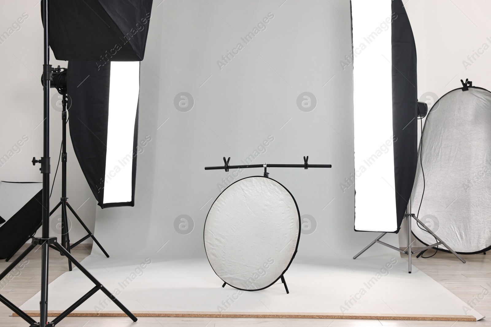 Photo of Professional lighting equipment setup in modern photo studio