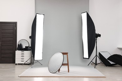 Photo of Professional lighting equipment setup in modern photo studio