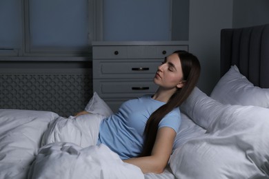 Photo of Young woman suffering from sleepwalking on bed at home