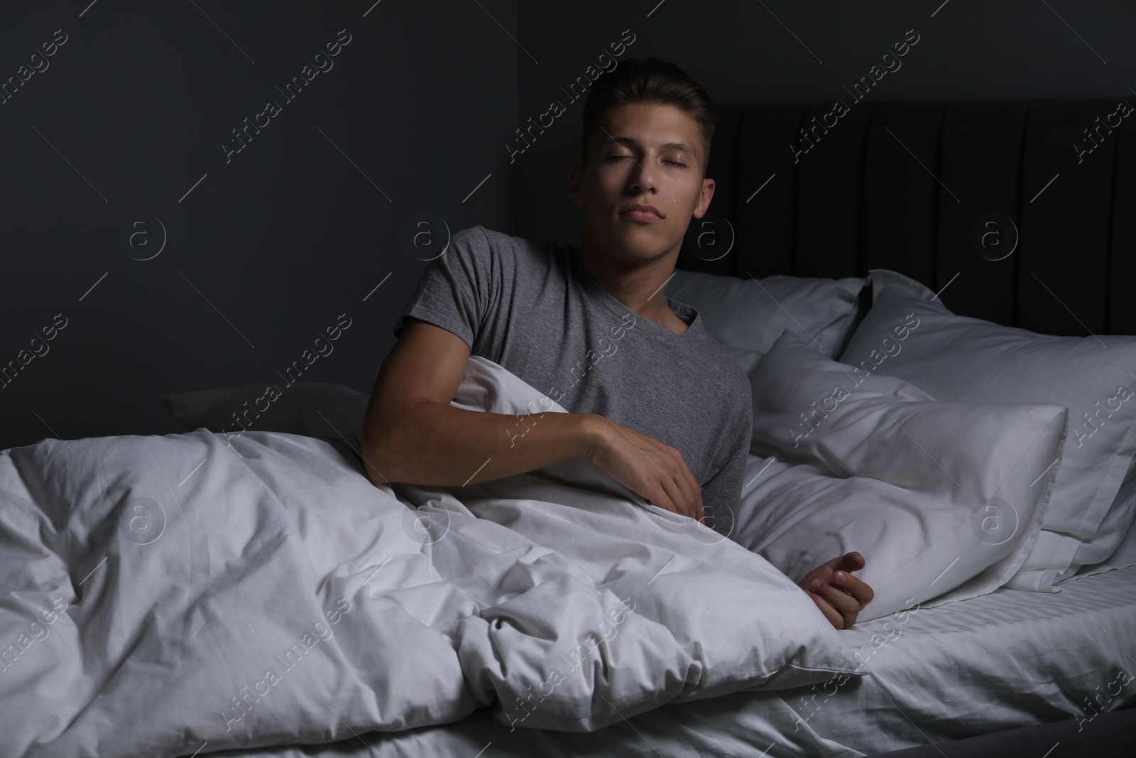 Photo of Young man suffering from sleepwalking on bed at home