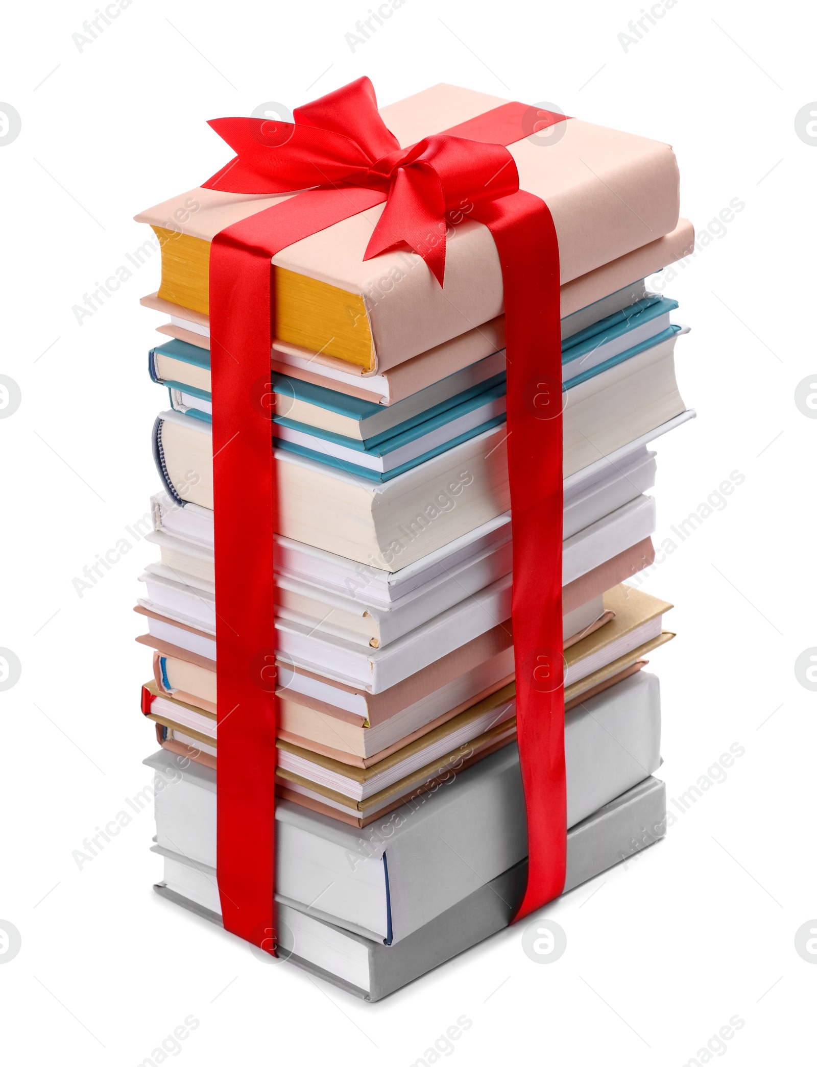 Photo of Stack of books with red ribbon as gift isolated on white