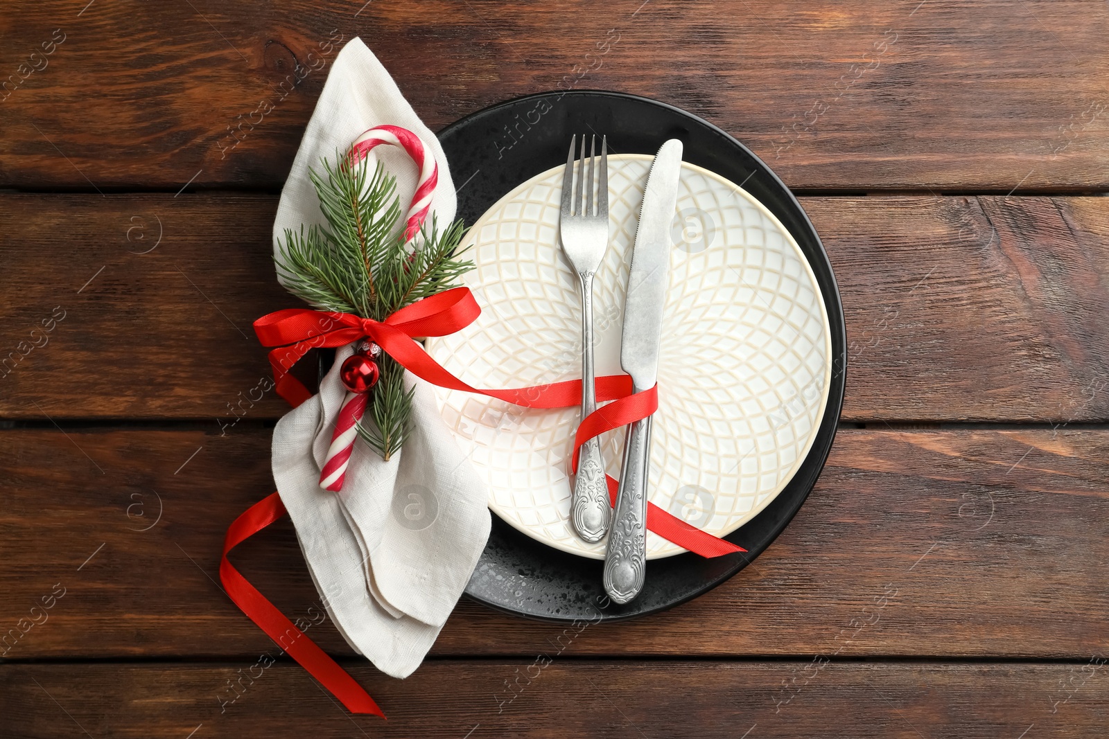 Photo of Christmas setting with festive decor on wooden table, top view