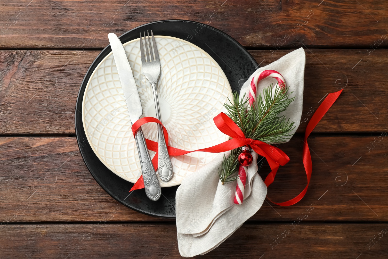 Photo of Christmas setting with festive decor on wooden table, top view