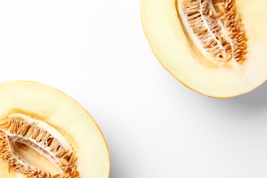 Photo of Halves of fresh melon on white background, top view