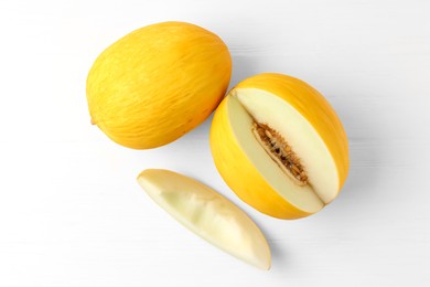 Photo of Fresh ripe melons on white table, top view