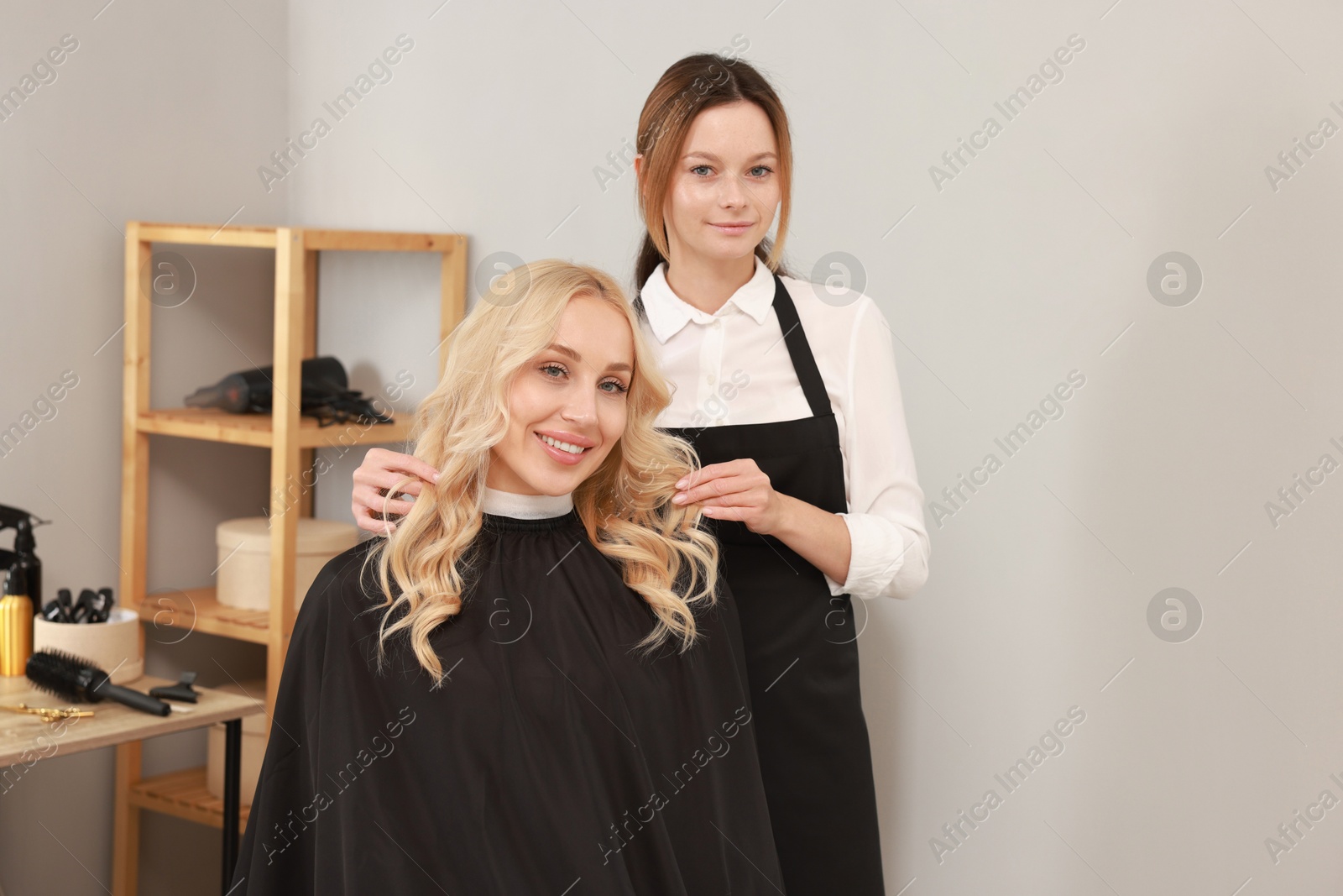 Photo of Hair cutting. Professional hairdresser working with client in salon