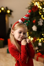 Little girl with Christmas ornament at home