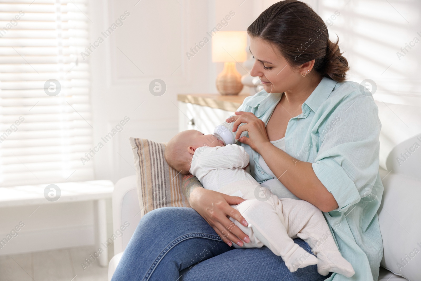 Photo of Mother feeding her cute baby at home