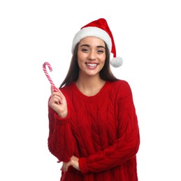 Photo of Young woman in red sweater and Santa hat holding candy cane on white background. Celebrating Christmas