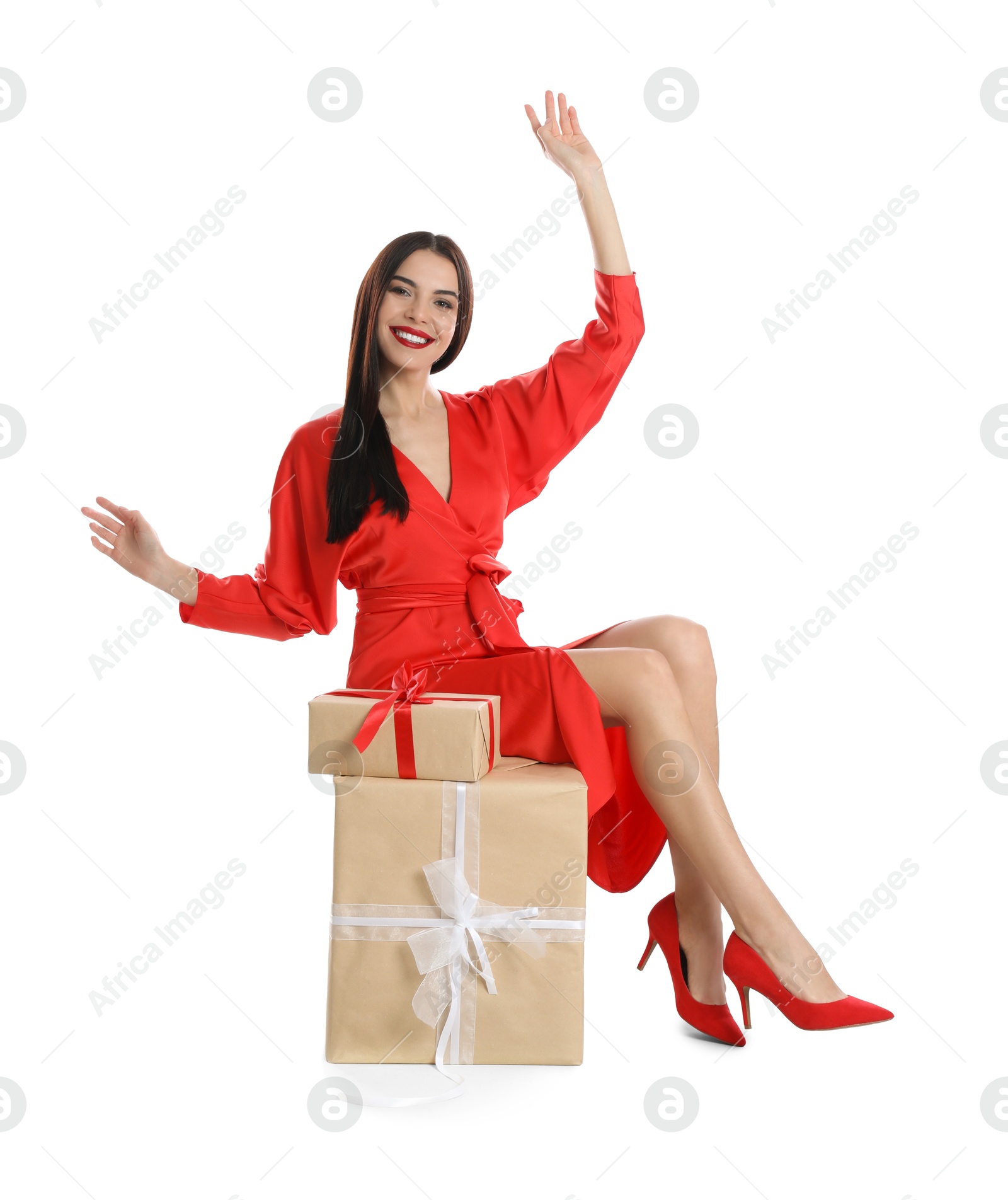 Photo of Woman in red dress with Christmas gifts on white background