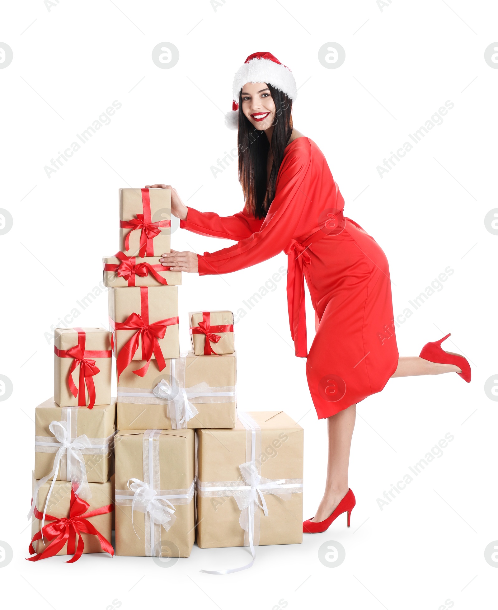 Photo of Woman in red dress and Santa hat with Christmas gifts on white background