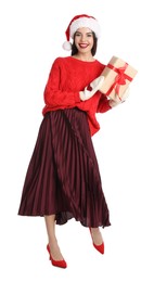 Photo of Woman in Santa hat, knitted mittens and red sweater holding Christmas gift on white background