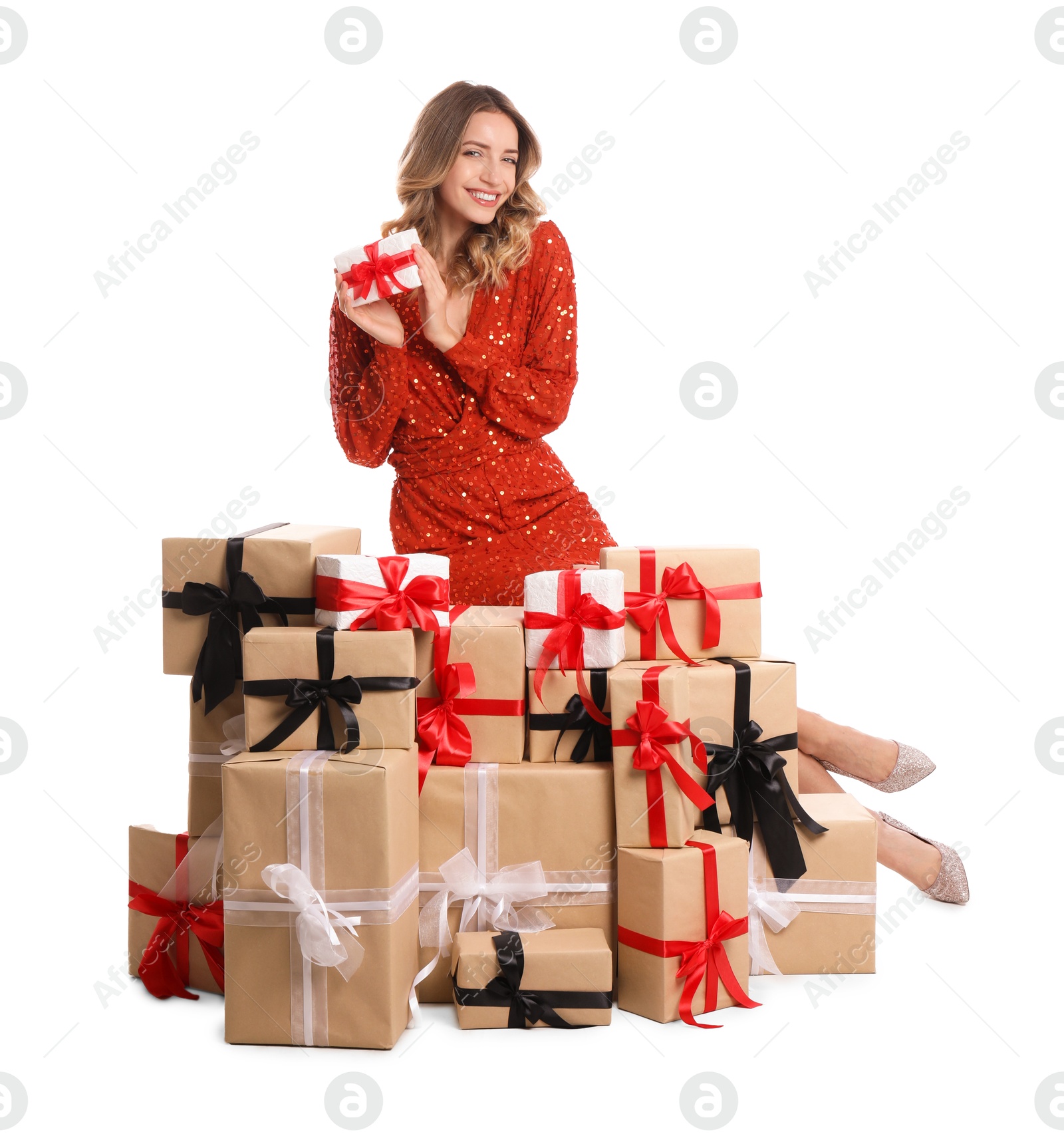 Photo of Beautiful young woman with pile of Christmas presents on white background