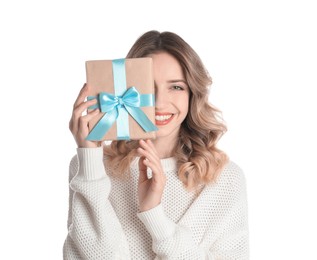 Photo of Beautiful young woman with Christmas present on white background